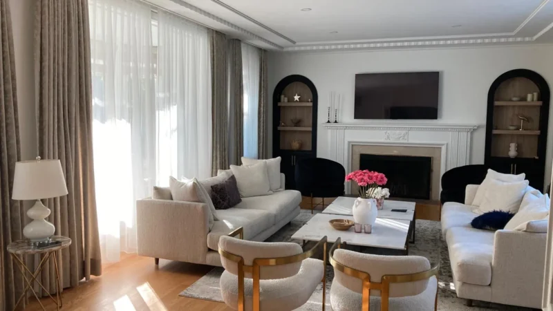 Living room with a TV, fireplace, table, couches and chairs
