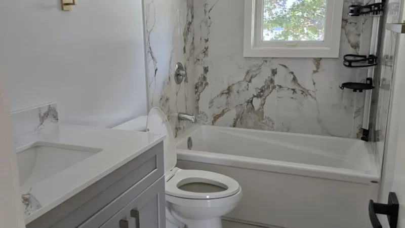 Bathroom with a sink, toilet, bathtub and window