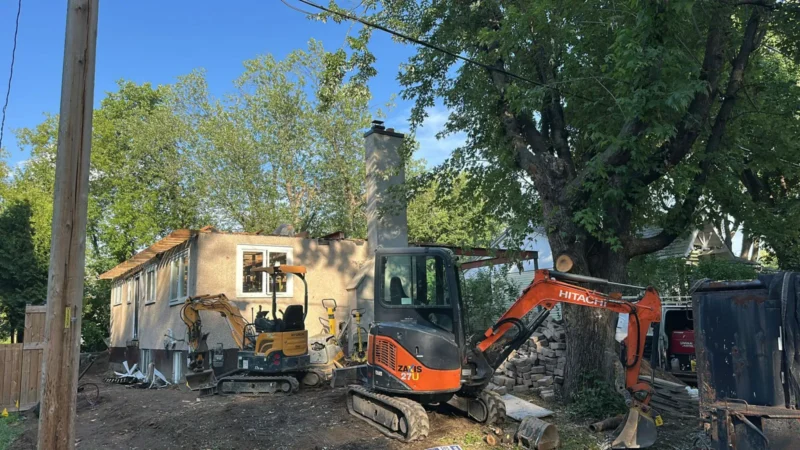 House under construction, excavator